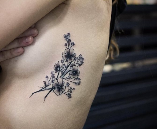 Flower tattoo on the side under chest