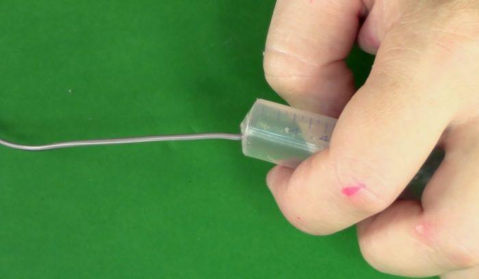 The wire end is inserted into the syringe