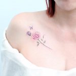 Beautiful tattoo on the collarbone of a girl