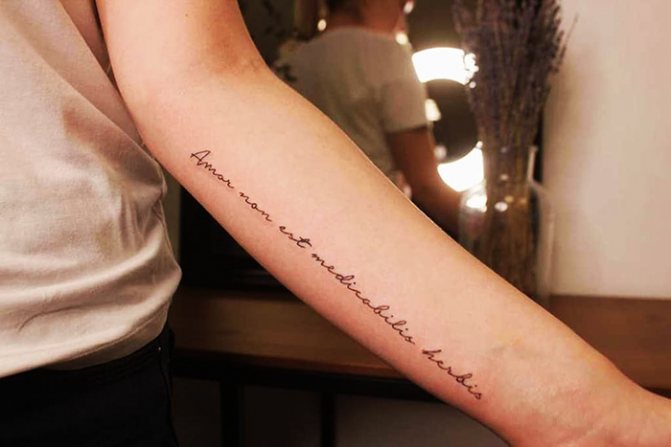 Beautiful phrase on the tattoo of the girl, the boy