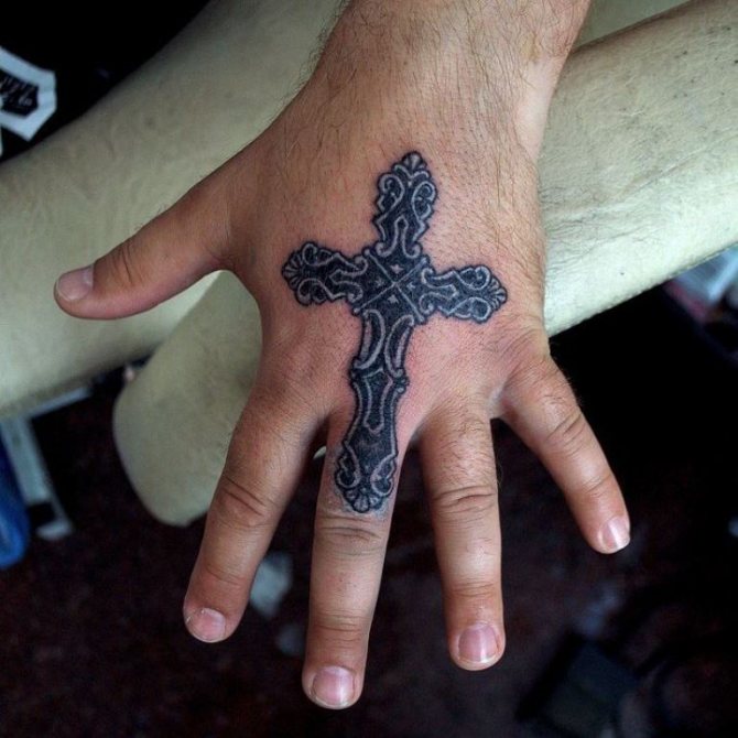 cross on thumb tattoo
