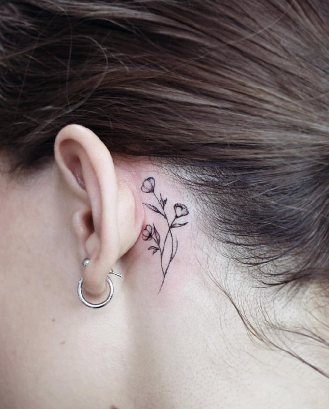 Small tattoo behind the ear