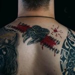 a man with a slavic tattoo on his back