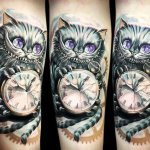 Tattoo of a cheshire cat on his arm