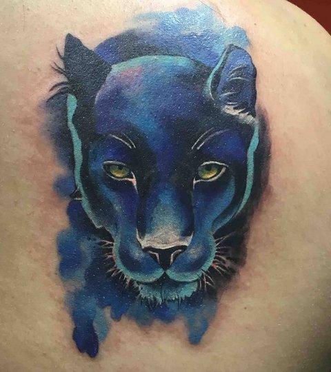 Colored panther head tattoo