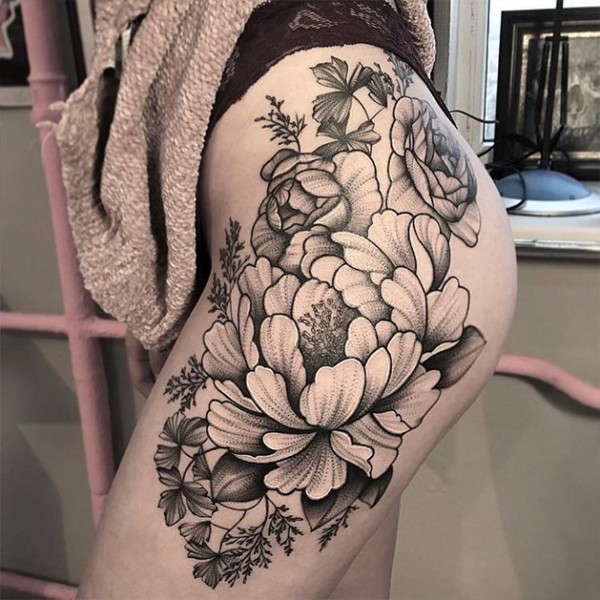 girls black flowers tattoo on her thigh