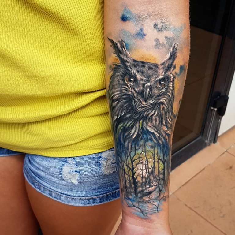 Tattoo of an owl and a forest