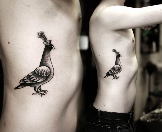 Tattoo of a dove on the ribs