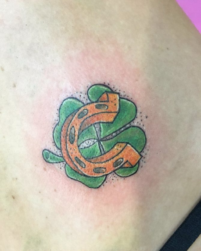Tattoo of a clover and a horseshoe