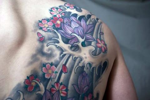 Tattoo water lily on his scapula