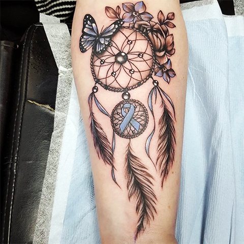 Tattoo of a dream catcher and butterfly