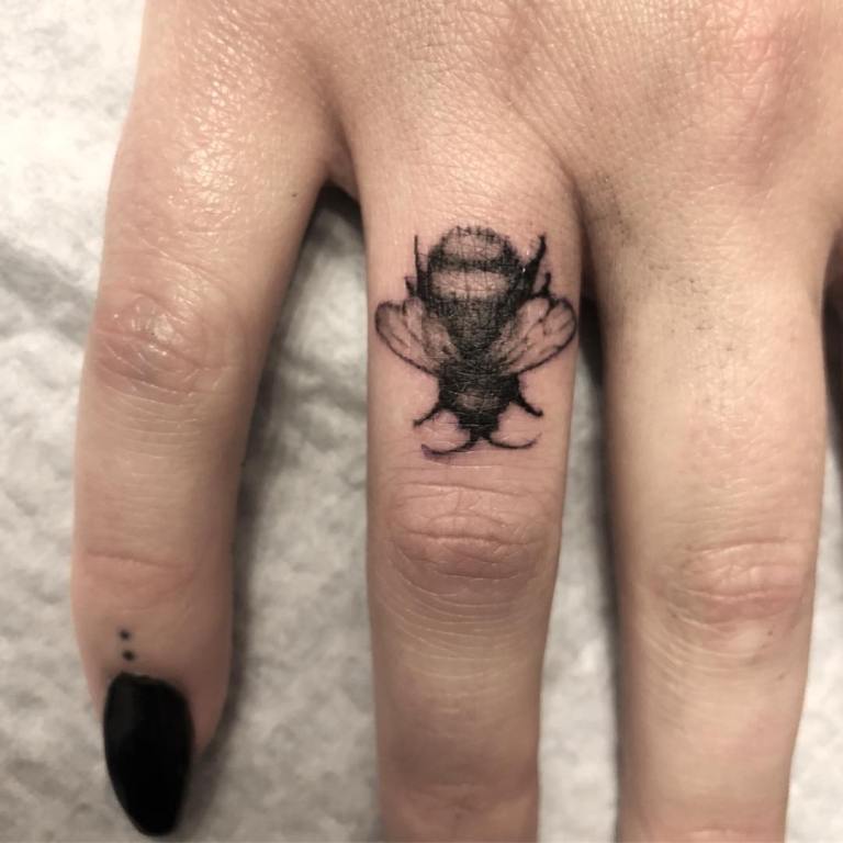 Tattoo on right ring finger