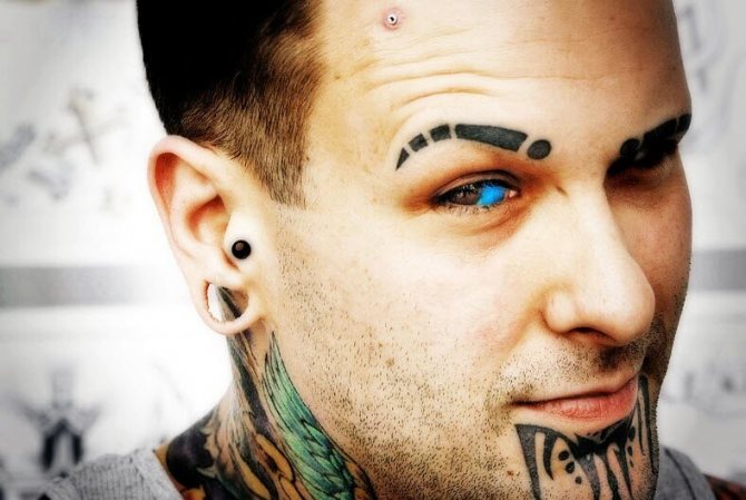 Tattoo on the eyeball with blue paint