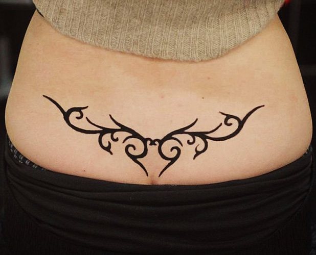 Tattoo on the coccyx for girls. Photo and meaning