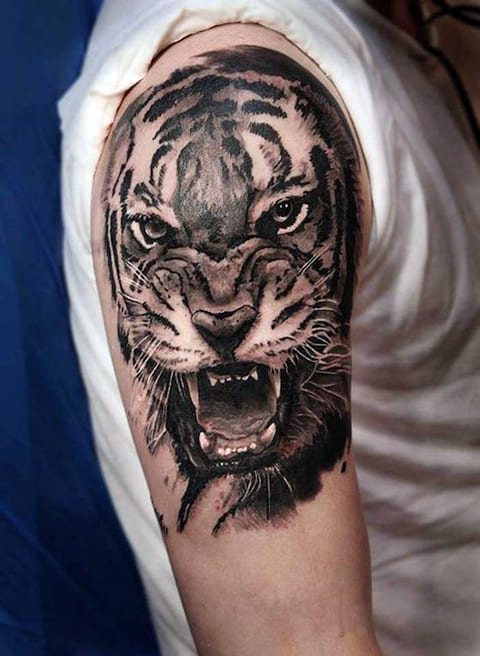 Tattoo of a tiger grinning on her shoulder