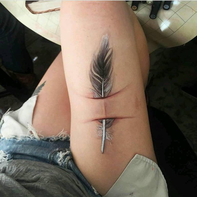 Tattoo of a feather for girls