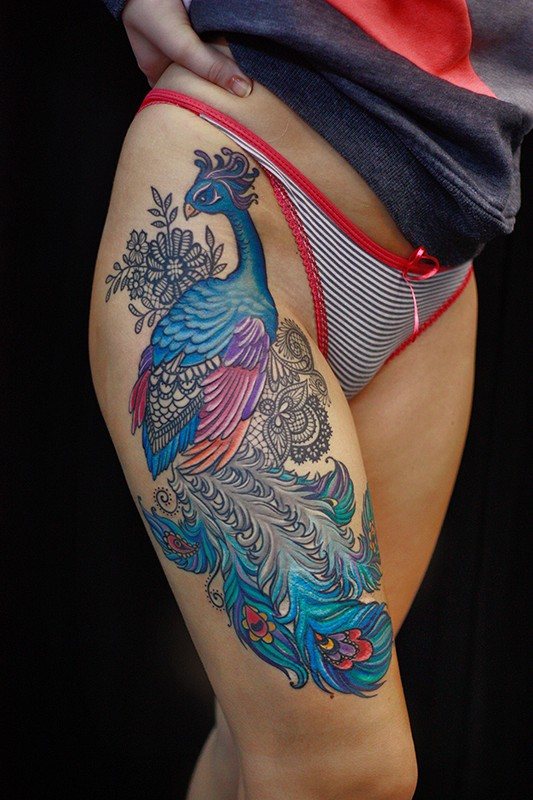 Tattoo of a feather - meaning in a girl with a word, birds, peacock on the leg, arm, wrist, stomach, neck, back, collarbone, on the side