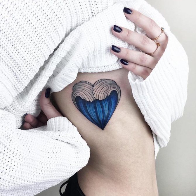 Tattoo heart under the ribs