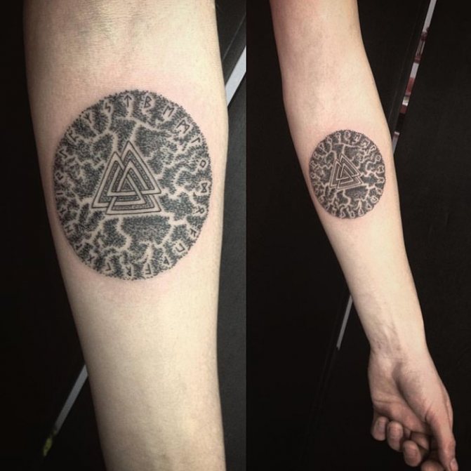 Blackwork rune tattoo on forearm