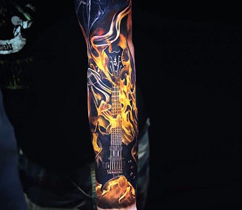 Tattoo element of fire with guitar on his arm