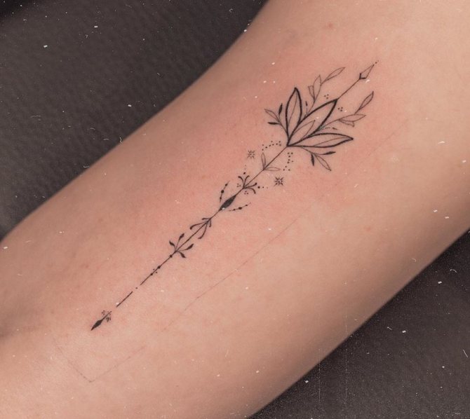 tattoo arrow on his arm