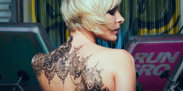 Lace tattoo on the back of a girl