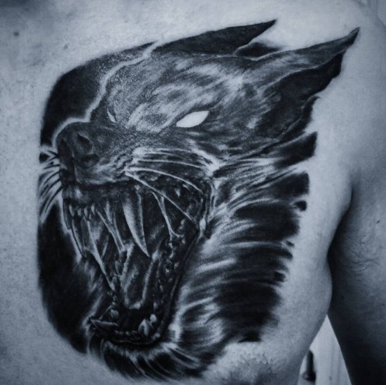 Tattoo of a werewolf on his chest, the grin