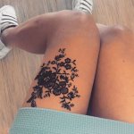 Tattoo in the form of lace with a vet on a girl's leg